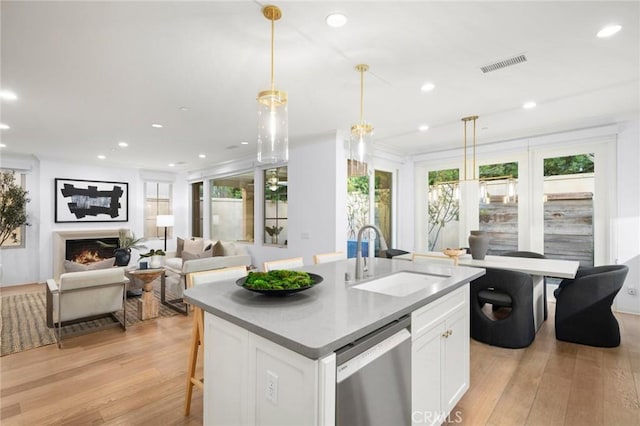 42 Cipresso, Irvine, CA 92618 - kitchen featuring a sink, dishwasher, light wood-type flooring, white cabinets, and recessed lighting