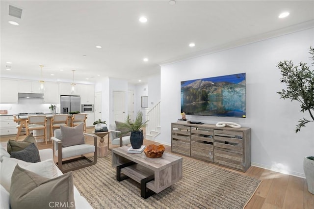 42 Cipresso, Irvine, CA 92618 - living area with recessed lighting, light wood-style floors, stairway, baseboards, and ornamental molding