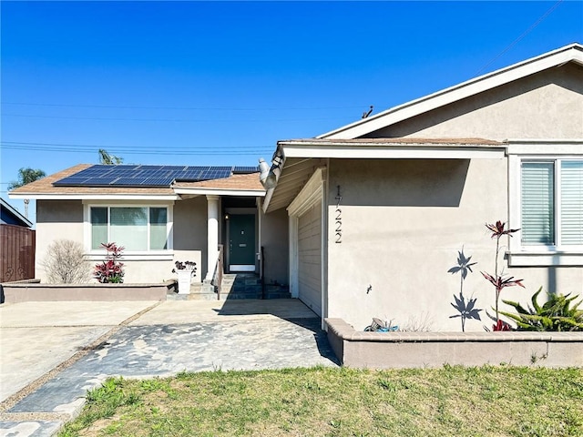 17222 Wall St, Carson, CA 90746 - view of front of house with roof with shingles, an attached garage, stucco siding, and solar panels
