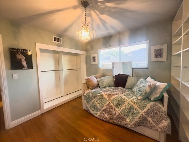 17222 Wall St, Carson, CA 90746 - bedroom with wood finished floors, an inviting chandelier, baseboards, and visible vents