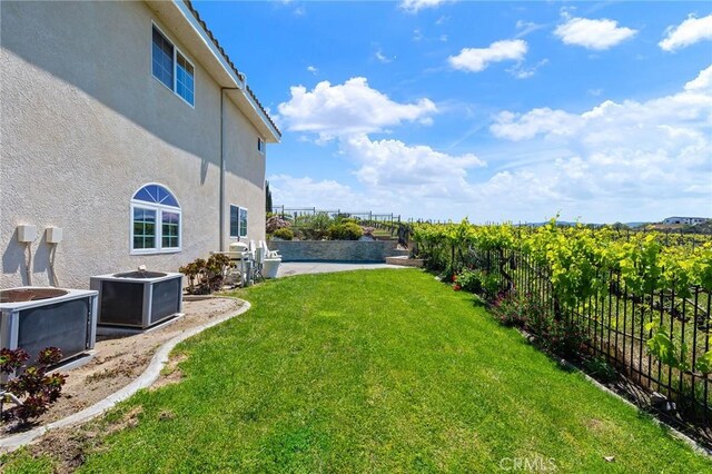 view of yard featuring a fenced backyard and central air condition unit