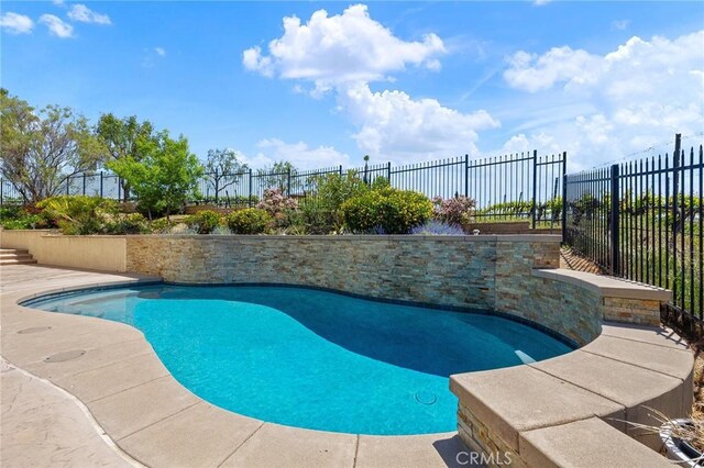 view of swimming pool with a fenced in pool and fence