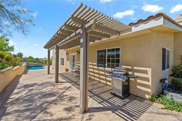 view of patio / terrace featuring a fenced in pool, a pergola, and grilling area