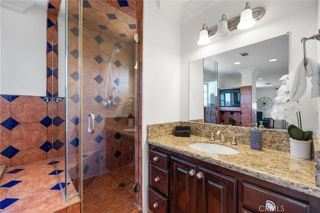 full bathroom with crown molding, vanity, visible vents, and a shower stall