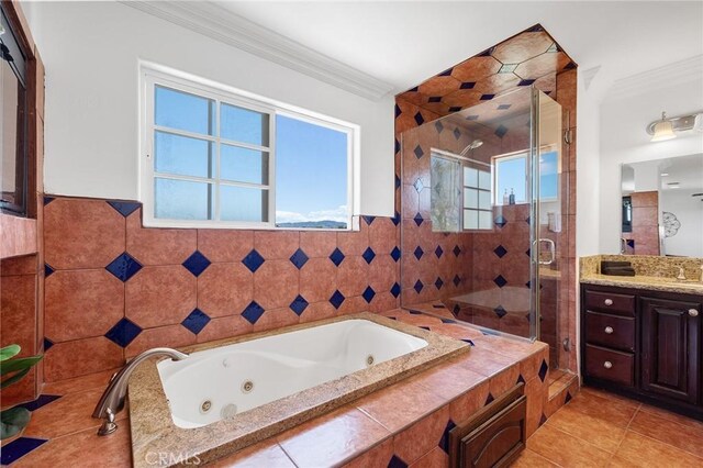 bathroom featuring a jetted tub, tile patterned flooring, a shower stall, vanity, and ornamental molding