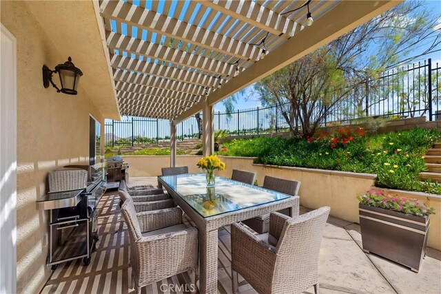 view of patio featuring fence, grilling area, outdoor dining space, and a pergola