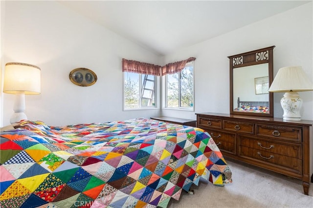 carpeted bedroom featuring lofted ceiling
