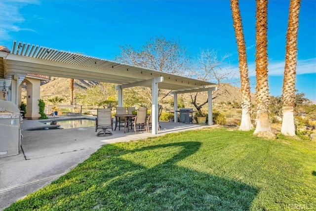 exterior space featuring a lawn, a pergola, a patio, and a swimming pool