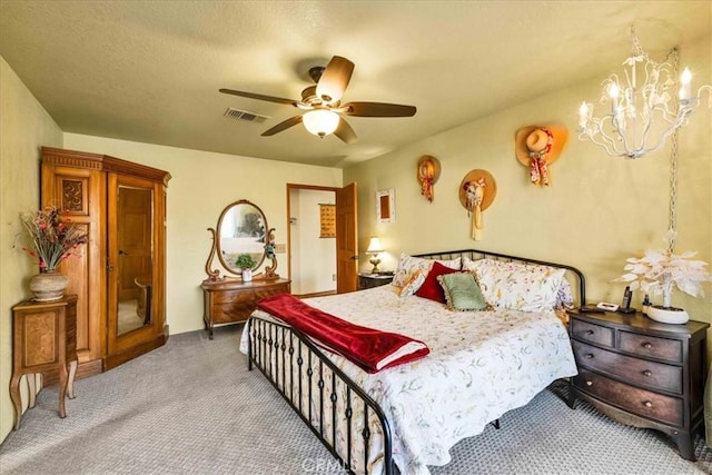 bedroom with ceiling fan with notable chandelier, visible vents, and carpet