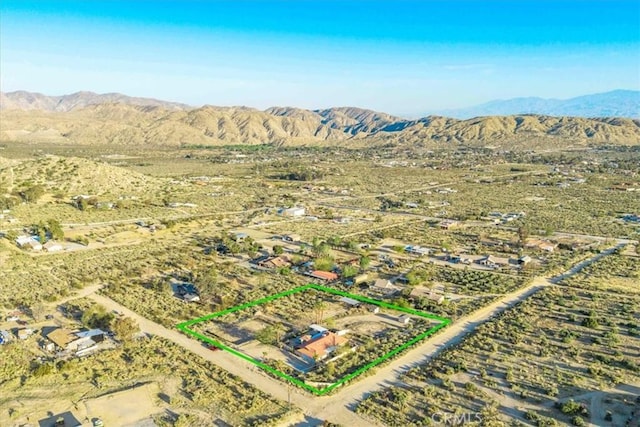 birds eye view of property with a mountain view