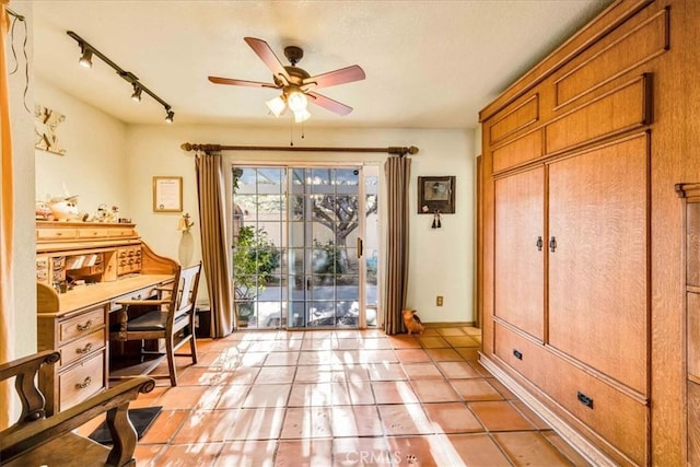 doorway to outside with a ceiling fan, track lighting, and light tile patterned floors