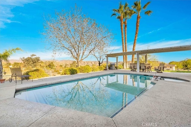 outdoor pool with a patio area