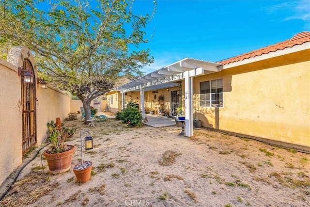 view of yard featuring a pergola, fence, and a patio