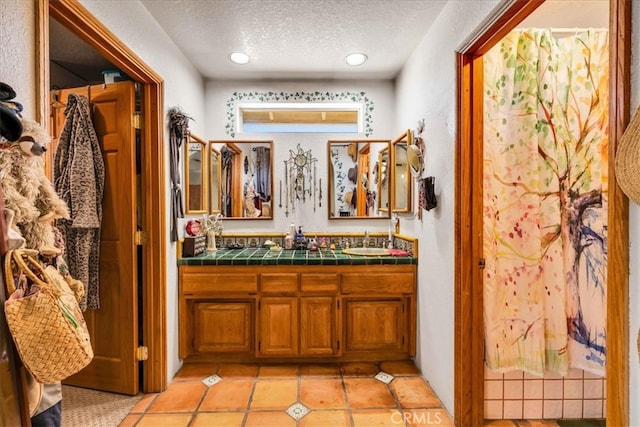 bathroom with vanity and a textured ceiling