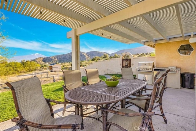 10341 Pinon Ave, Morongo Valley, CA 92256 - view of patio featuring a mountain view, outdoor dining area, and a pergola