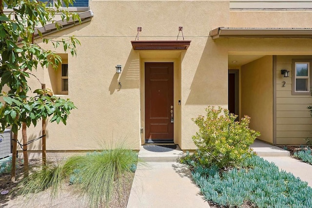 doorway to property with stucco siding