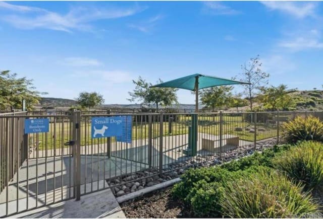 view of pool featuring fence and a gate