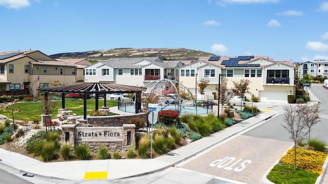 view of home's community with a residential view, a gazebo, and an attached garage