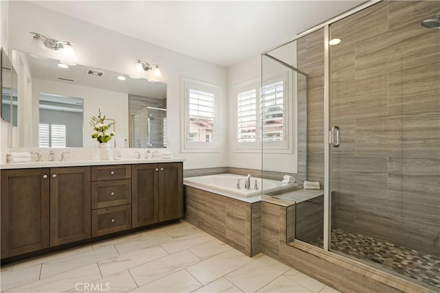 full bathroom featuring a shower stall, a garden tub, double vanity, and marble look tile flooring