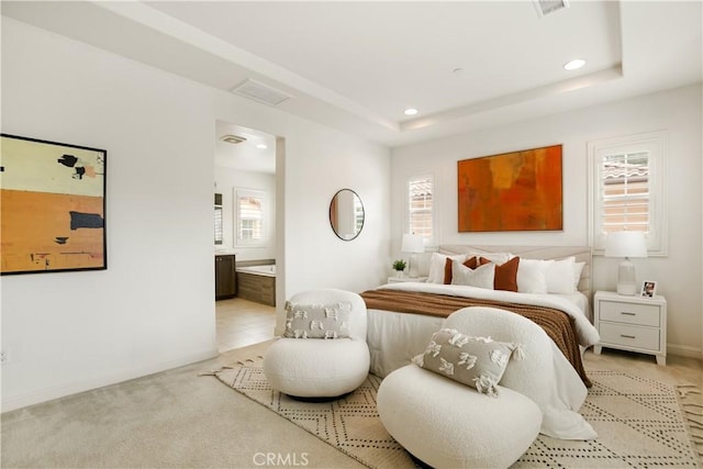 bedroom featuring recessed lighting, multiple windows, ensuite bathroom, and baseboards
