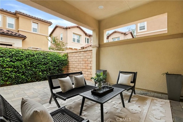view of patio / terrace featuring an outdoor hangout area and fence