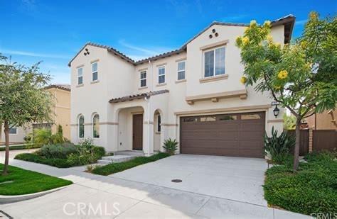mediterranean / spanish-style house with stucco siding, a garage, concrete driveway, and a tile roof