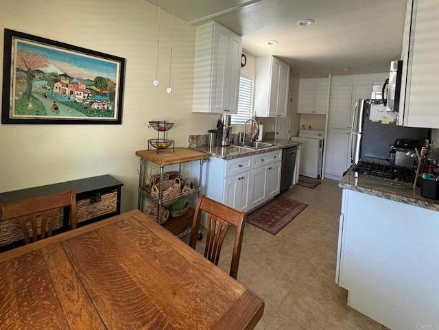 kitchen featuring white cabinets, dishwasher, a sink, independent washer and dryer, and tile patterned floors