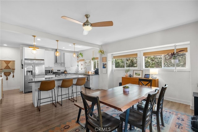 dining space with recessed lighting, baseboards, wood finished floors, and ceiling fan