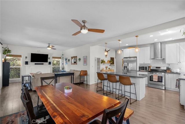 dining space featuring recessed lighting, light wood finished floors, and ceiling fan