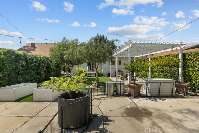 view of patio / terrace featuring a jacuzzi, a pergola, and a vegetable garden