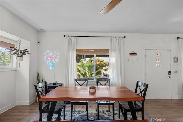 dining area featuring baseboards, light wood finished floors, and a ceiling fan