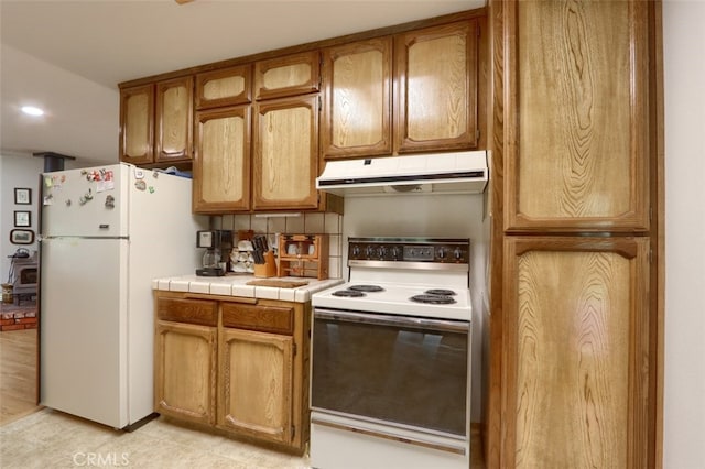 44410 Quail Ct, Coarsegold, CA 93614 - kitchen featuring under cabinet range hood, white appliances, tile countertops, and brown cabinetry