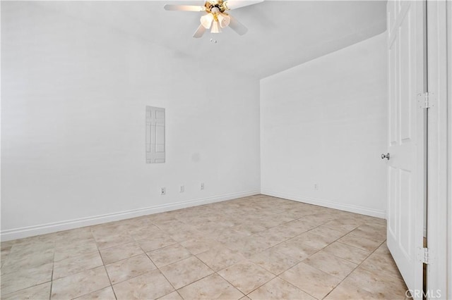 empty room with ceiling fan and baseboards