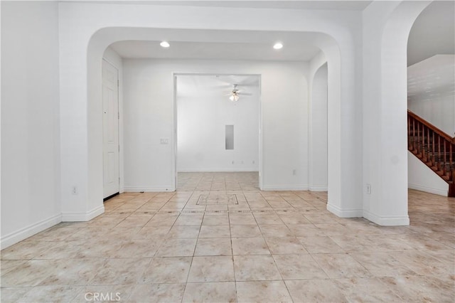 tiled spare room with recessed lighting, arched walkways, stairway, and ceiling fan