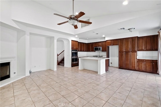 kitchen with visible vents, recessed lighting, arched walkways, and stainless steel appliances