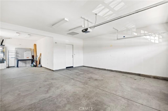 garage featuring a garage door opener and baseboards
