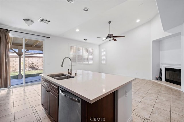 kitchen with a sink, visible vents, light tile patterned flooring, and dishwasher