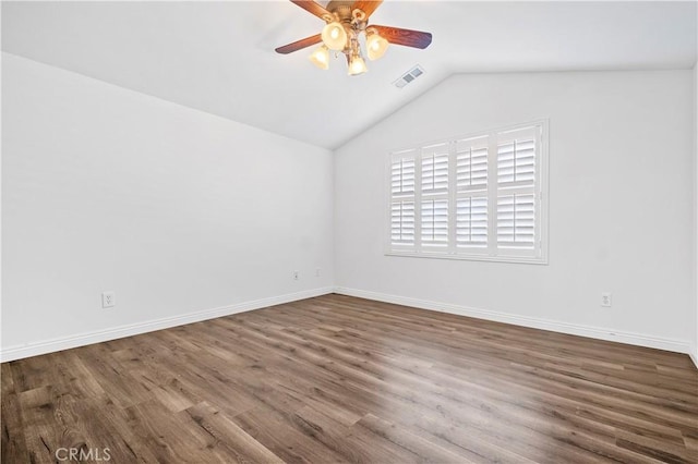 unfurnished room with visible vents, baseboards, ceiling fan, wood finished floors, and lofted ceiling