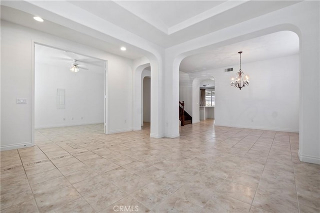empty room featuring ceiling fan with notable chandelier, visible vents, arched walkways, and recessed lighting