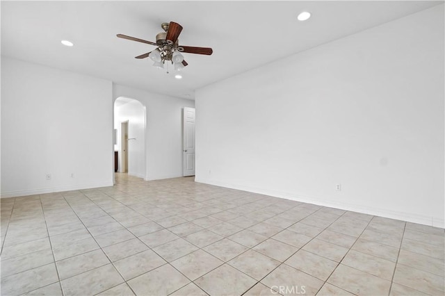 spare room featuring a ceiling fan, arched walkways, and recessed lighting