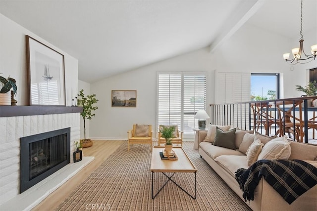 living area with a notable chandelier, a wealth of natural light, vaulted ceiling with beams, and wood finished floors