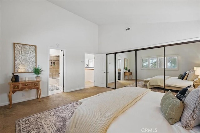 bedroom with high vaulted ceiling, baseboards, carpet floors, and visible vents