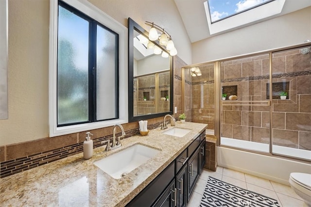 full bathroom featuring tile patterned flooring, a sink, and a healthy amount of sunlight