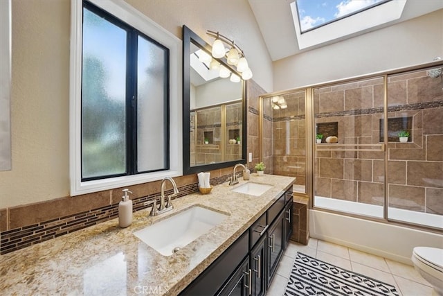 2707 Vanderbilt Ln Unit 1, Redondo Beach, CA 90278 - full bath featuring a skylight, double vanity, tile patterned flooring, shower / bath combination with glass door, and plenty of natural light
