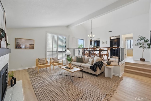 2707 Vanderbilt Ln Unit 1, Redondo Beach, CA 90278 - living area with a chandelier, a fireplace with raised hearth, and light wood-style floors