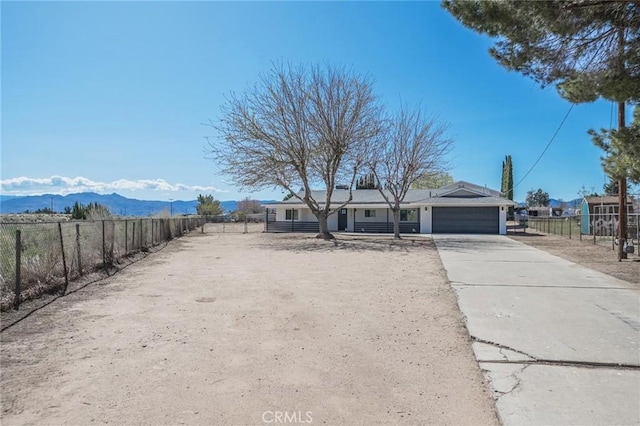 15029 Larch St, Hesperia, CA 92345 - view of front of house with a mountain view, fence, a garage, and concrete driveway