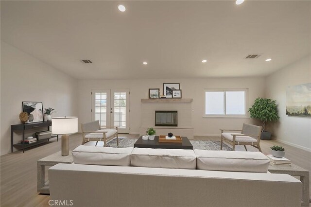 15029 Larch St, Hesperia, CA 92345 - living area featuring light wood-style floors, a healthy amount of sunlight, and visible vents