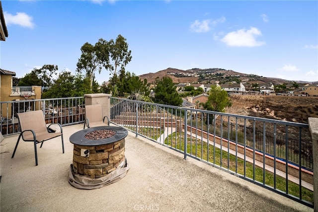 16219 Skyridge Dr, Riverside, CA 92503 - view of patio / terrace with a fire pit, a mountain view, and a balcony
