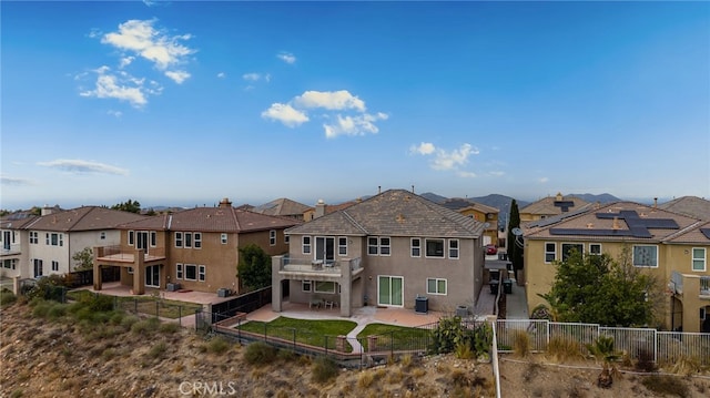 16219 Skyridge Dr, Riverside, CA 92503 - back of house featuring a residential view, stucco siding, a patio area, and a fenced backyard