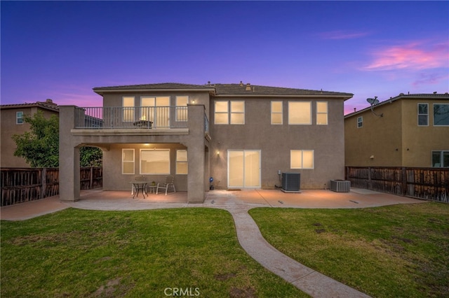 16219 Skyridge Dr, Riverside, CA 92503 - back of house at dusk featuring a balcony, a patio area, stucco siding, and central AC unit